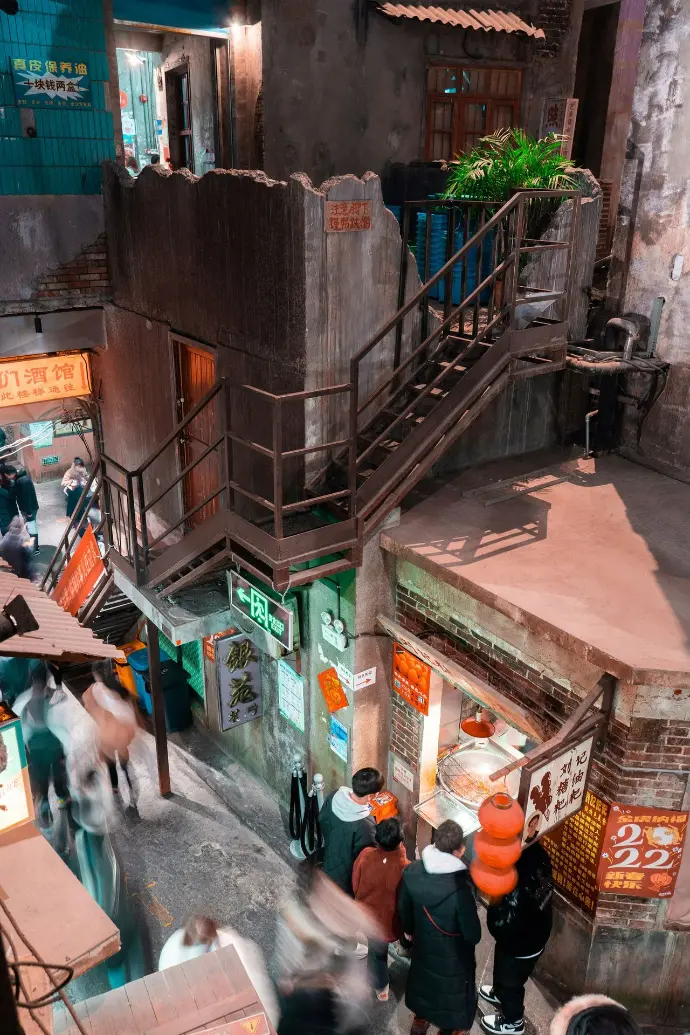 a group of people walking down a narrow street